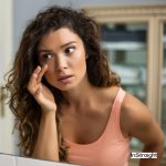 a woman watching her eyebags